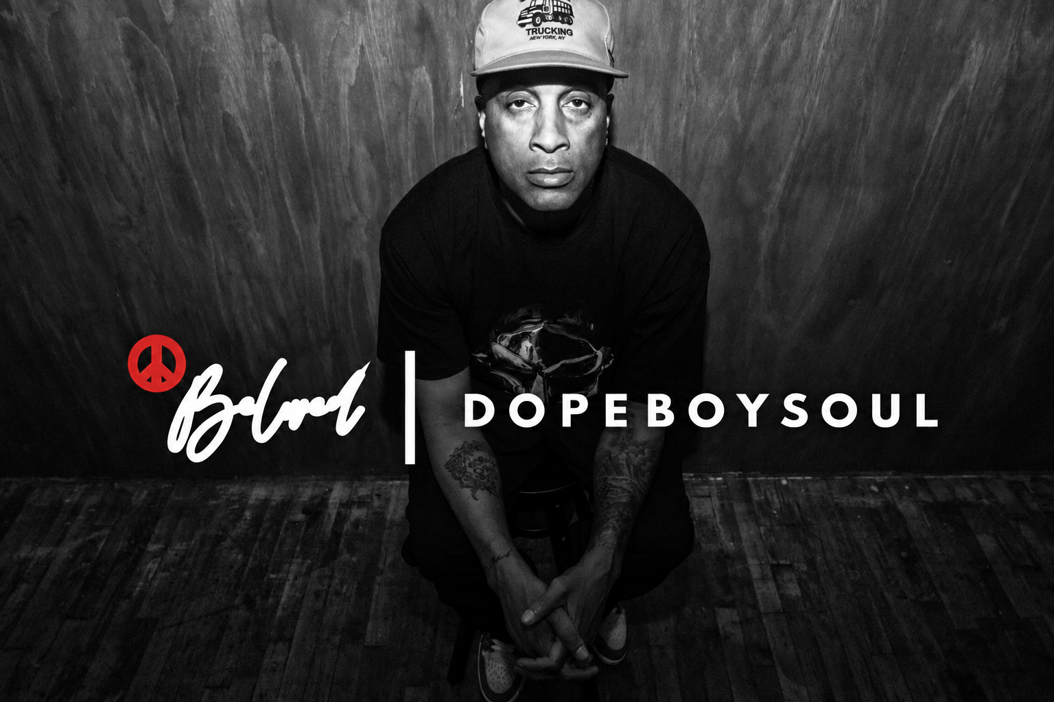 Black-and-white portrait of AMXXR with the white Beloved and DopeBoySoul lettering and red peace sign